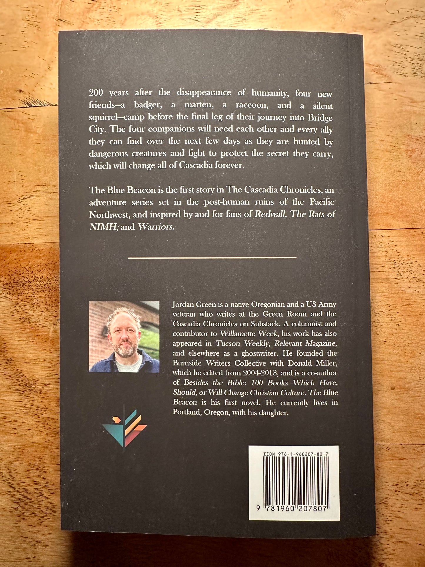 a top down view of the back of the blue beacon set on a wood desk