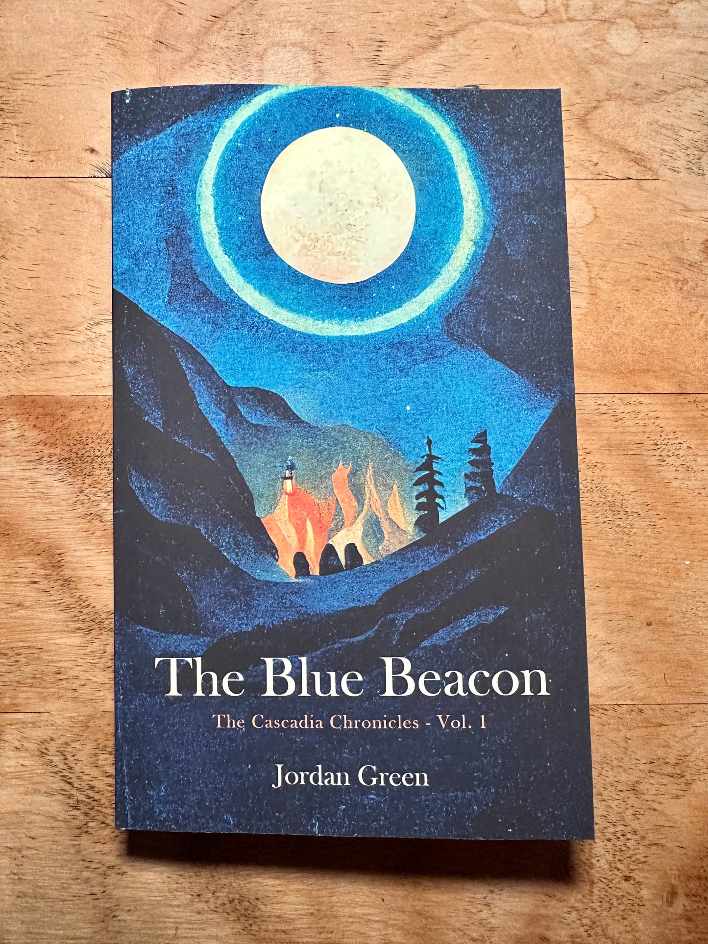 A top down perspective of the front cover of the blue beacon on a wooden desk